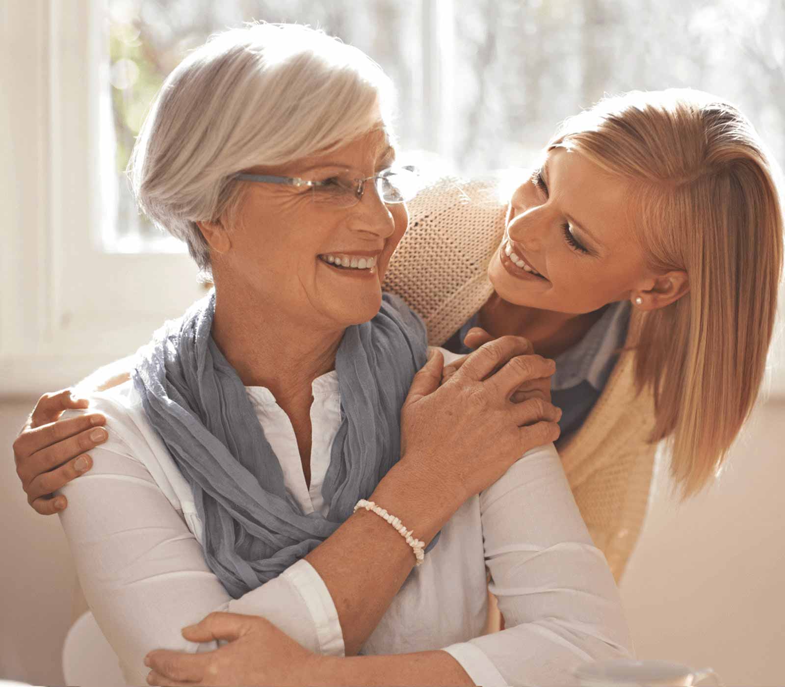 A happy mother and her daughter embrace